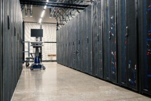 Rows of AI server racks inside a modern hyperscale data center powering artificial intelligence infrastructure.