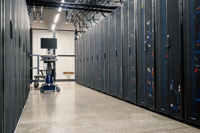 Rows of AI server racks inside a modern hyperscale data center powering artificial intelligence infrastructure.
