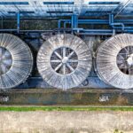 Large industrial cooling fans on a commercial facility as economies expand cooling infrastructure to cope with rising temperatures.
