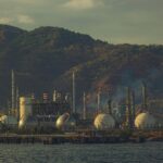 Oil refinery facility processing crude oil as global energy markets react to the Iran-US ceasefire and changing supply expectations.