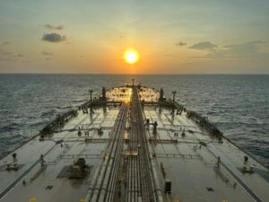 Oil tanker at sea during sunset as markets react to the reopening of the Strait of Hormuz following the U.S.-Iran ceasefire.
