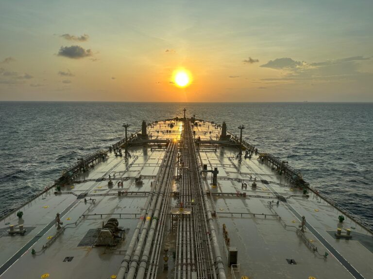 Oil tanker at sea during sunset as markets react to the reopening of the Strait of Hormuz following the U.S.-Iran ceasefire.