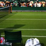 Grass court at Wimbledon with spectators watching during the Championships, illustrating how tradition and live experiences create lasting value in the digital age.