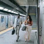 Young professionals commuting in a transit station as economic research highlights changing attitudes toward work, homeownership and financial security.