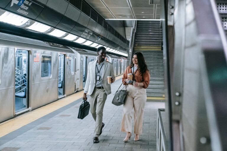 Young professionals commuting in a transit station as economic research highlights changing attitudes toward work, homeownership and financial security.