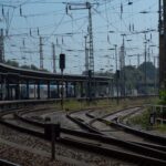 Railway tracks and overhead power lines at a European rail junction, illustrating infrastructure exposed to extreme summer heat and climate stress.