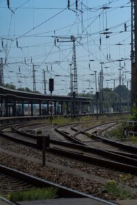Railway tracks and overhead power lines at a European rail junction, illustrating infrastructure exposed to extreme summer heat and climate stress.