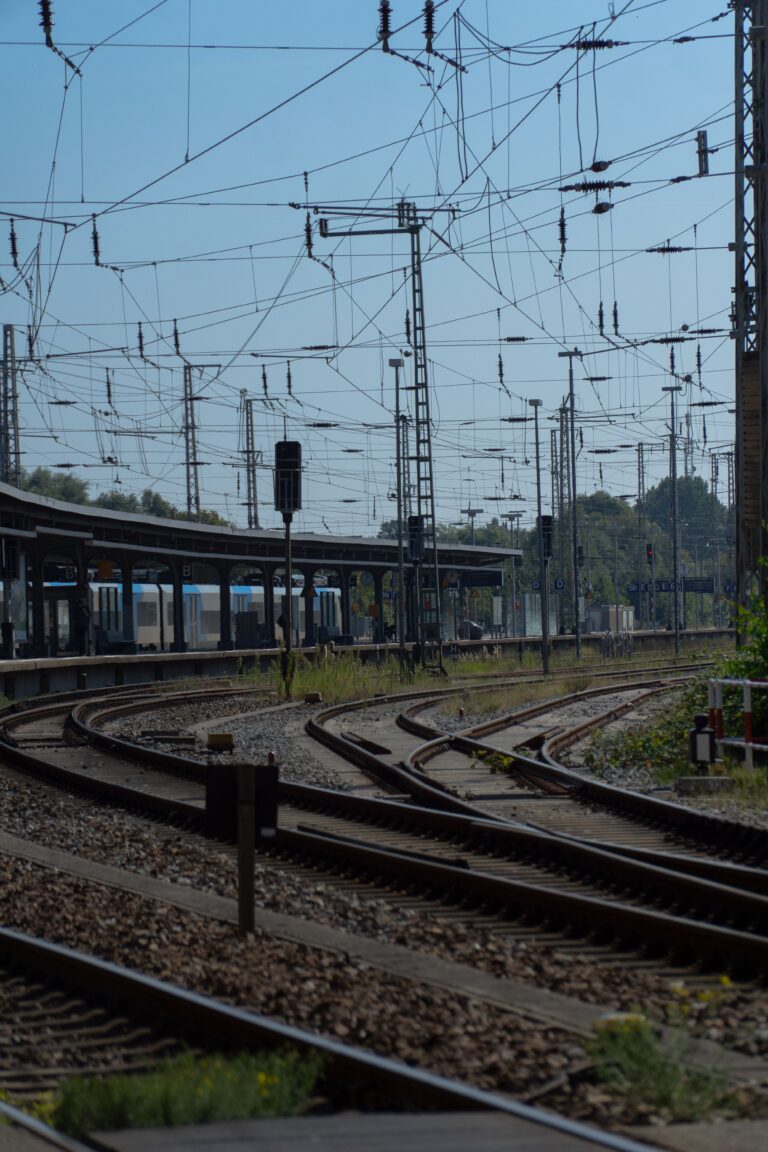 Railway tracks and overhead power lines at a European rail junction, illustrating infrastructure exposed to extreme summer heat and climate stress.