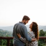 A couple embracing while overlooking a scenic landscape, symbolizing trust, commitment and modern relationships.