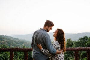 A couple embracing while overlooking a scenic landscape, symbolizing trust, commitment and modern relationships.