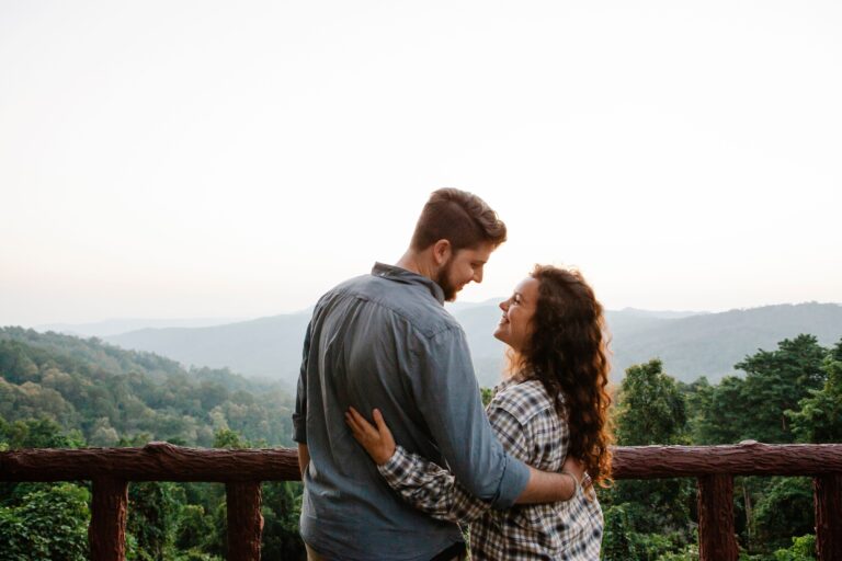 A couple embracing while overlooking a scenic landscape, symbolizing trust, commitment and modern relationships.