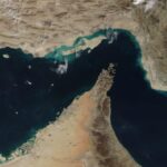 Satellite view of the Strait of Hormuz showing major global shipping lanes through one of the world's most important maritime chokepoints.