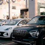 Large SUVs and cars displayed at a dealership, illustrating the shift away from affordable small cars.