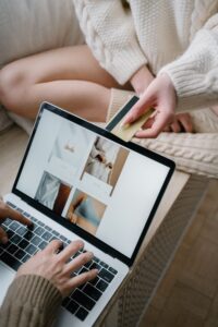Person shopping online with a credit card while browsing products on a laptop, illustrating Buy Now Pay Later and digital checkout financing.