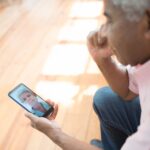 Person looking at a photograph of a loved one on a smartphone