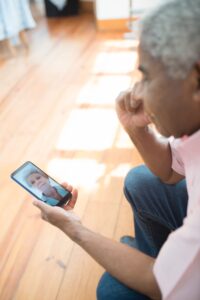 Person looking at a photograph of a loved one on a smartphone