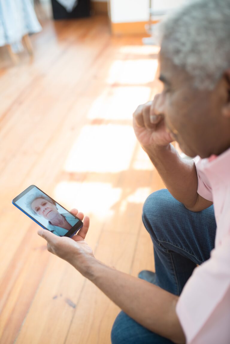 Person looking at a photograph of a loved one on a smartphone