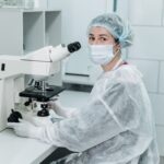 IVF laboratory specialist working with a microscope in a fertility clinic