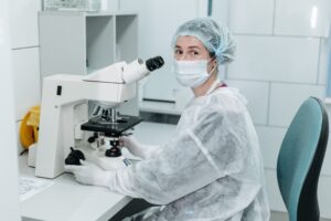IVF laboratory specialist working with a microscope in a fertility clinic