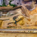 Aerial view of industrial sand extraction with heavy machinery in a large quarry