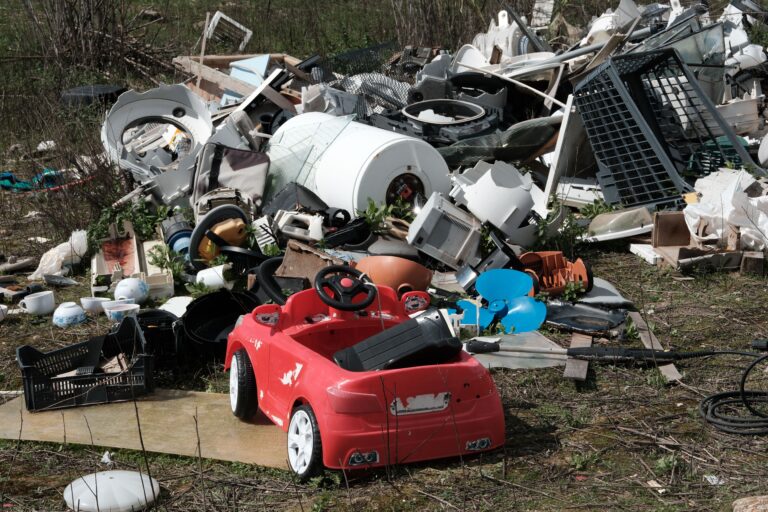 Pile of discarded household appliances and broken consumer products representing skimpflation and declining product durability