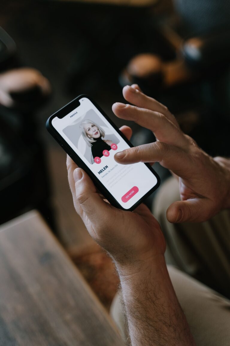 Person swiping through a dating app profile on a smartphone