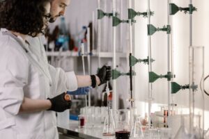 Scientists conducting pharmaceutical research in a laboratory developing new medicines, illustrating the economic challenges of antibiotic innovation.