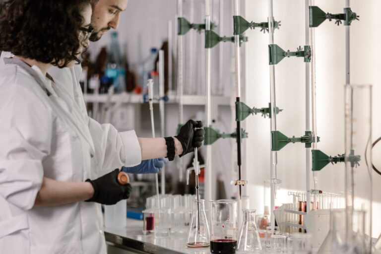 Scientists conducting pharmaceutical research in a laboratory developing new medicines, illustrating the economic challenges of antibiotic innovation.