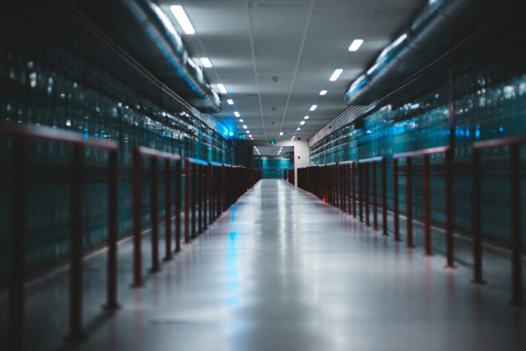 Long corridor inside a hyperscale data center with rows of AI server infrastructure