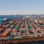 Large container port showing global shipping, logistics infrastructure, and international supply chains.