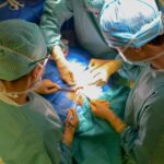 Surgeons performing an organ transplant operation in an operating room
