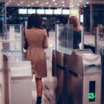 Traveler passing through a biometric airport gate using facial recognition