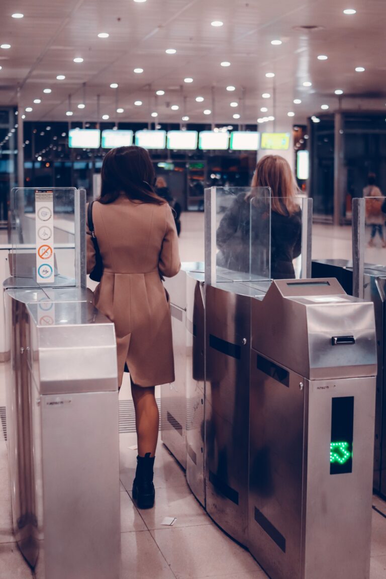 Traveler passing through a biometric airport gate using facial recognition