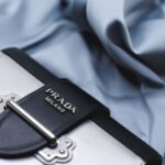 Close-up of a luxury handbag showing leather, stitching, hardware, and branded detail