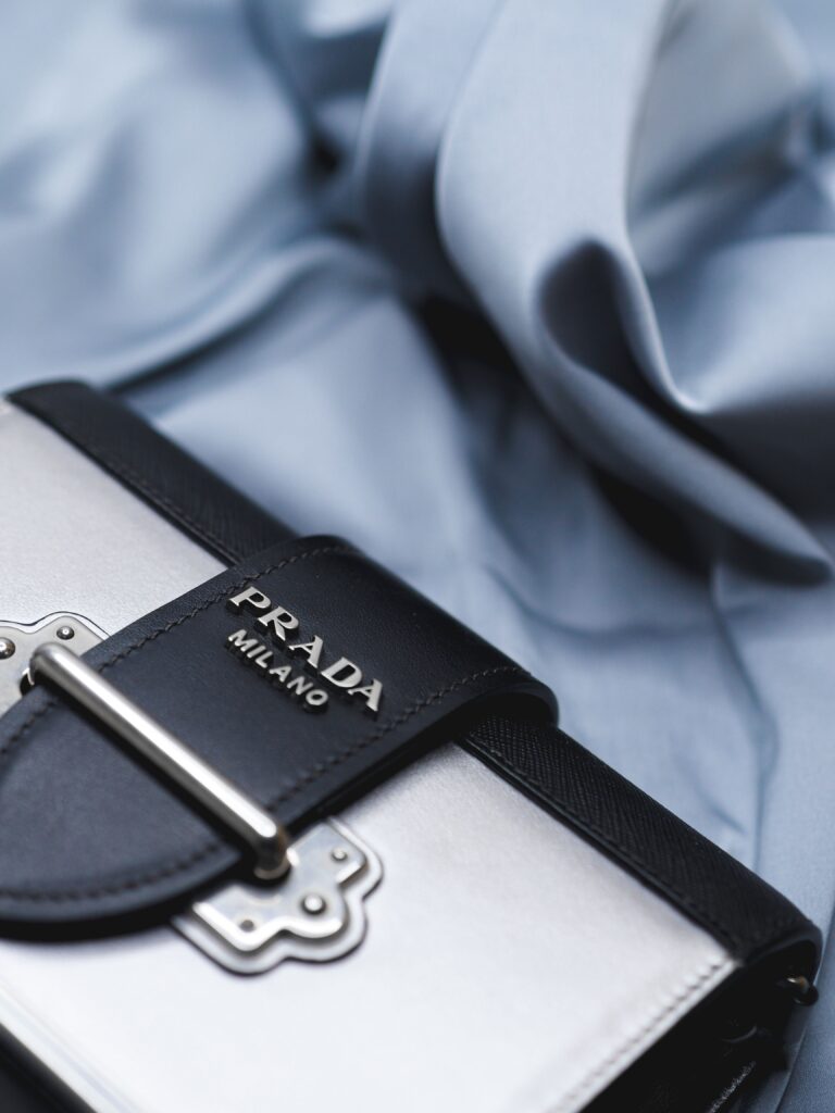 Close-up of a luxury handbag showing leather, stitching, hardware, and branded detail