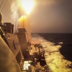 Missile launching from a U.S. Navy warship at sea, illustrating the cost of naval air defense against drone threats.