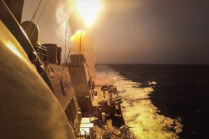 Missile launching from a U.S. Navy warship at sea, illustrating the cost of naval air defense against drone threats.