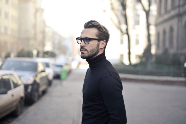 Man wearing black glasses on a city street, illustrating the future of everyday smart eyewear