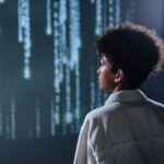 Person looking at streams of digital data representing algorithmic prediction