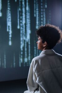Person looking at streams of digital data representing algorithmic prediction