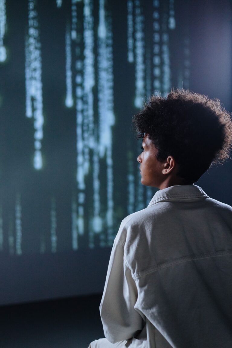 Person looking at streams of digital data representing algorithmic prediction
