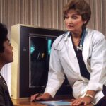 Female patient discussing medical imaging with a doctor during a clinical consultation.