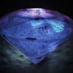Large faceted diamond illuminated in blue against a dark background