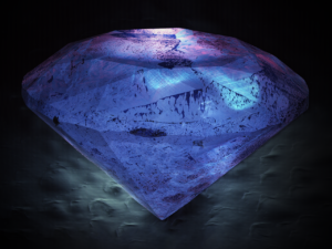 Large faceted diamond illuminated in blue against a dark background