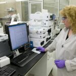 Scientist examining analytical results on laboratory equipment.