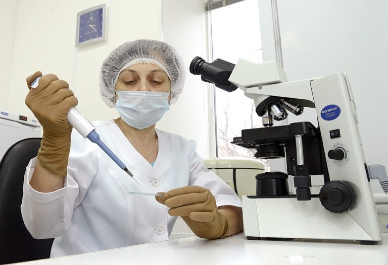 Embryologist working with laboratory equipment in a fertility research setting
